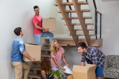 Professional house removals planning in Woodside with packed boxes and moving vehicle
