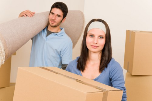 Professional movers carrying furniture for a Woodside house move